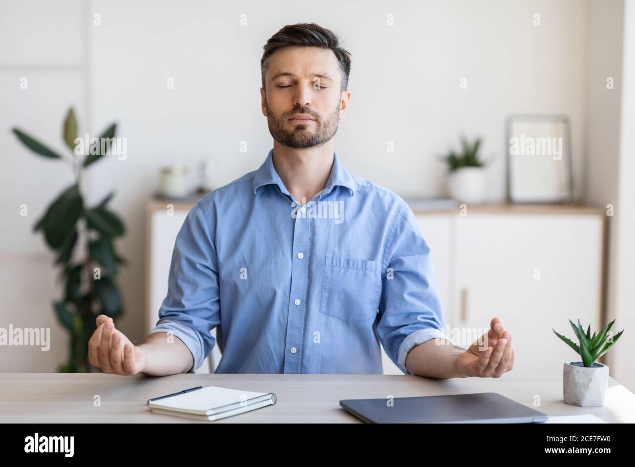 Office Zen. Relaxed Male Entrepreneur Meditating At Workplace, Coping