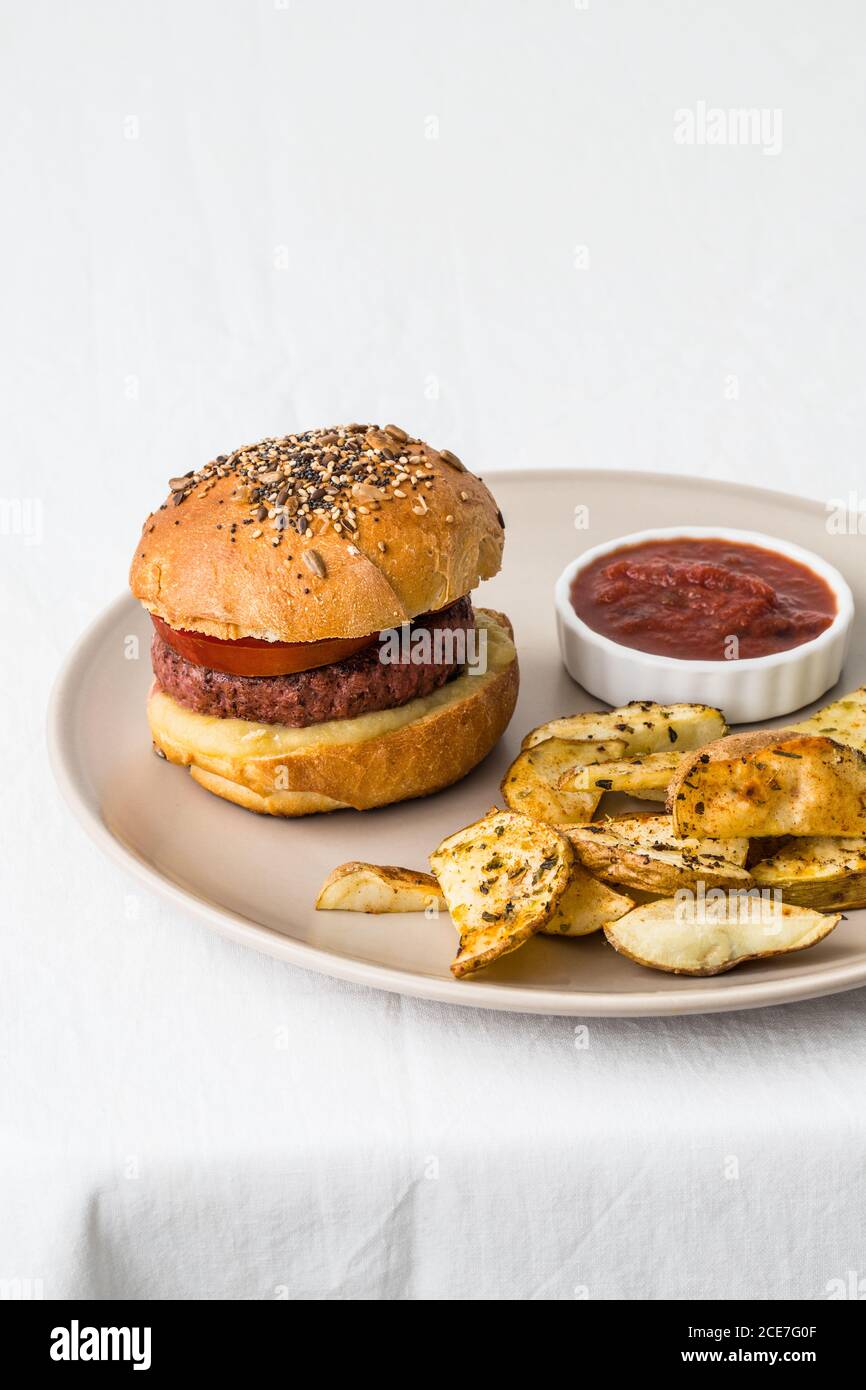 From above of delicious hamburger with meat cutlet and golden buns