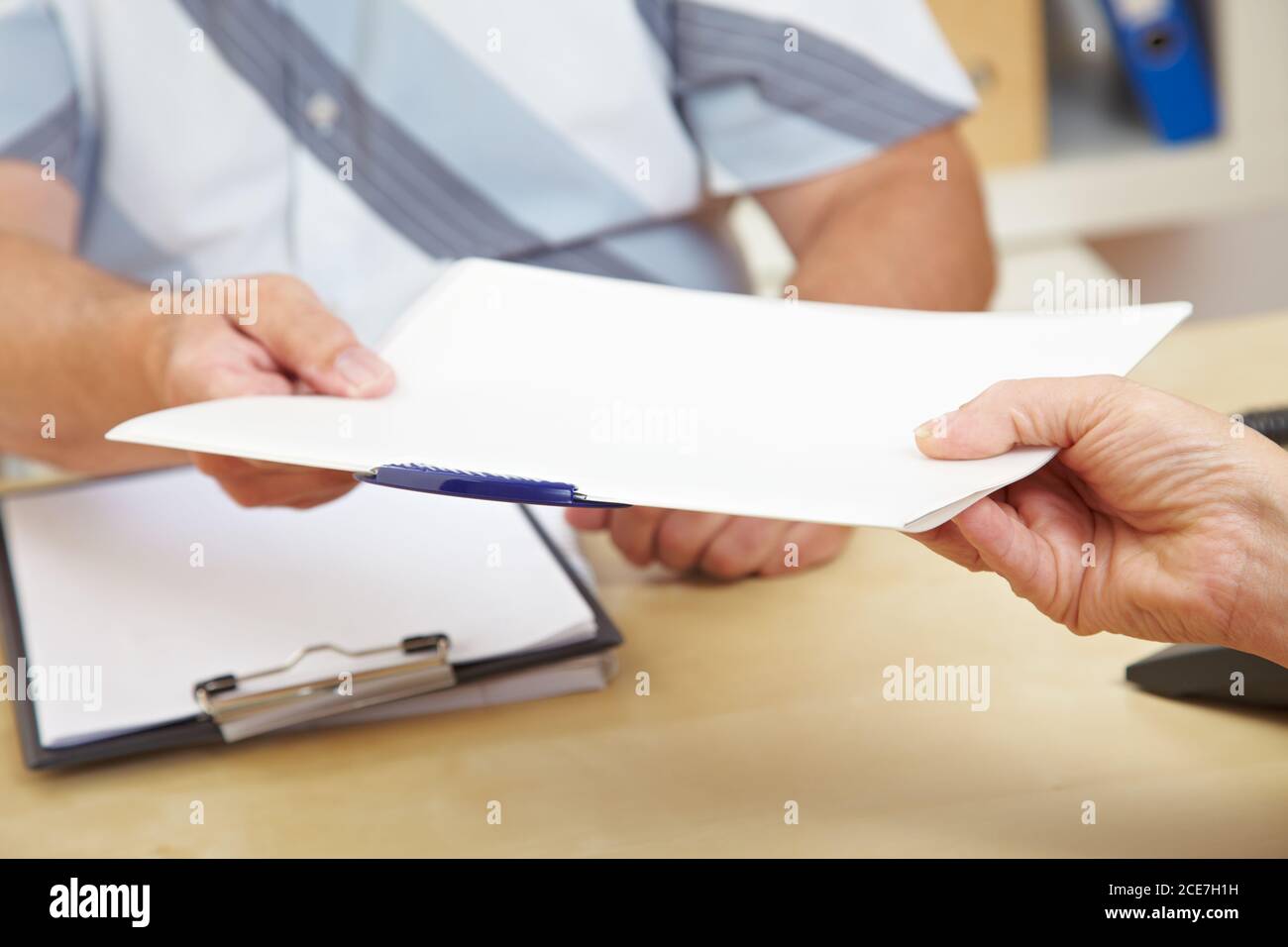 Woman hands in her application folder to the HR office Stock Photo