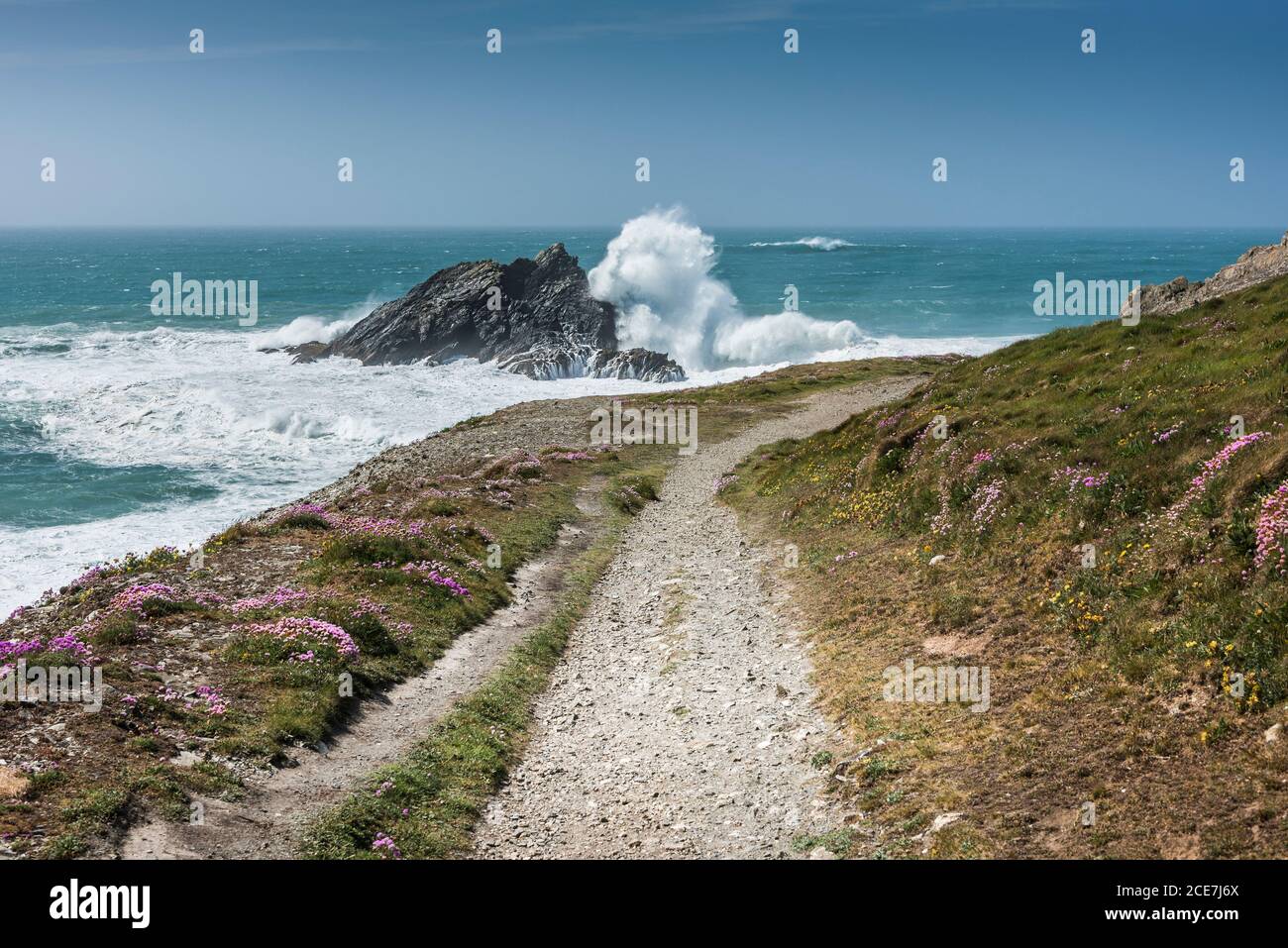 Wild waves crashing over Goose Island off Pentire Point East in Newquay in Cornwall. Stock Photo