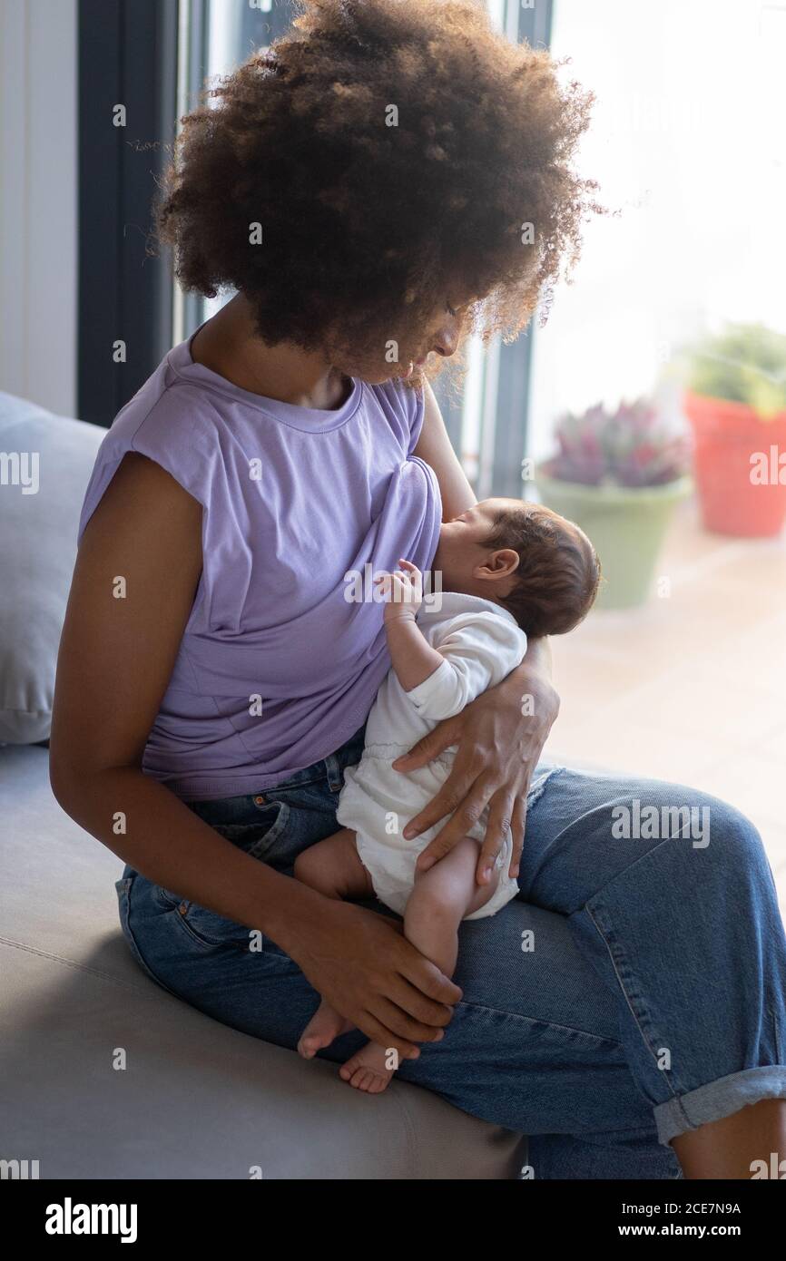 African American man feeding baby son bottle Stock Photo - Alamy