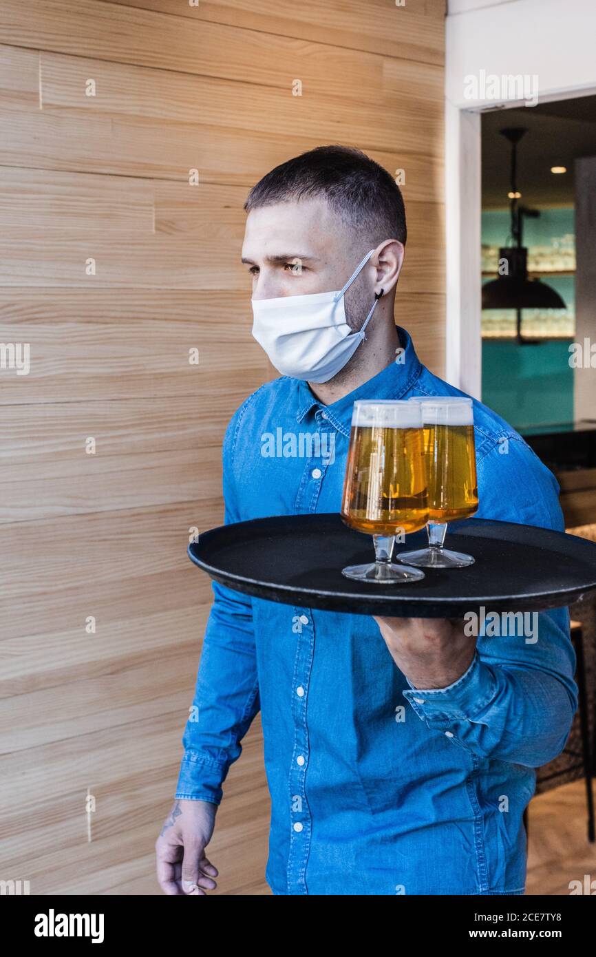 Waiter carrying tray hi-res stock photography and images - Alamy