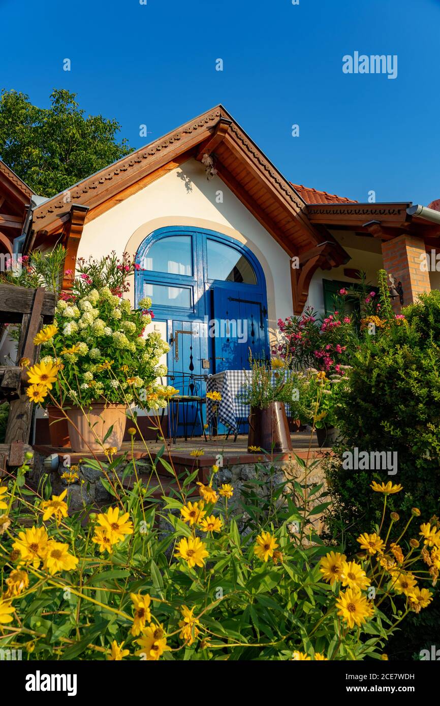 Colorful house entrance in Pecs Hungary with many flowers Stock Photo