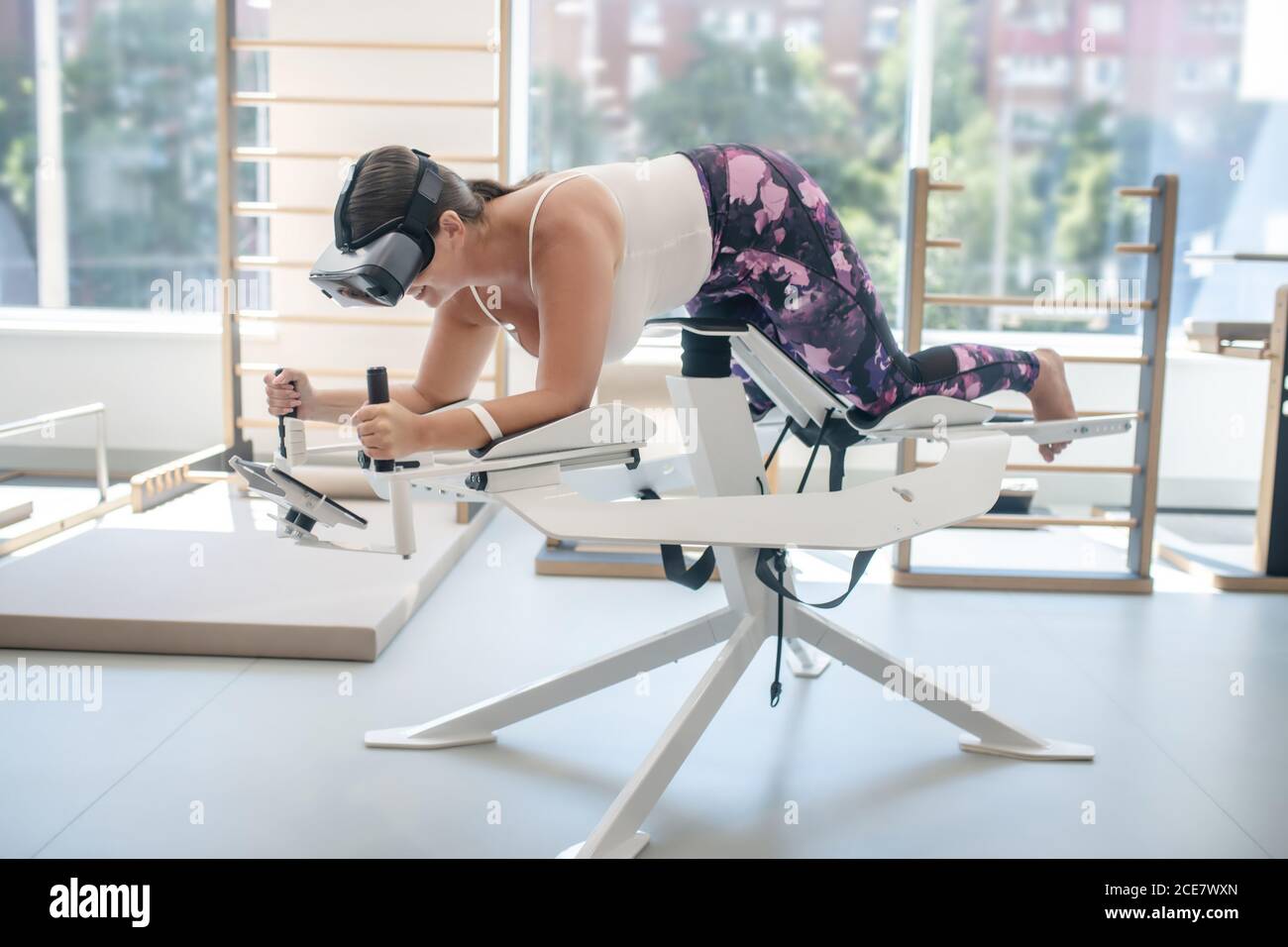 Woman enjoying playing with a VR simulator Stock Photo