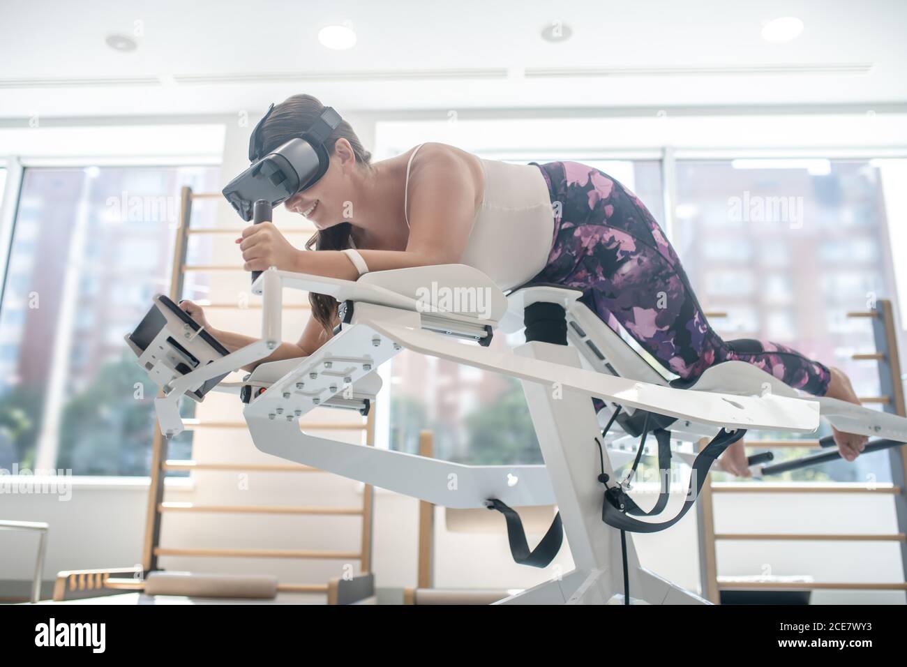 Woman playing a VR game using a VR simulator Stock Photo