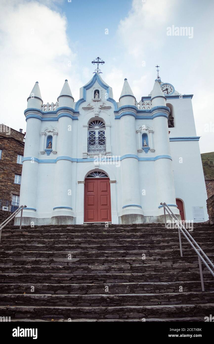 From below of facade of historic temple with pointed columns and cross ...