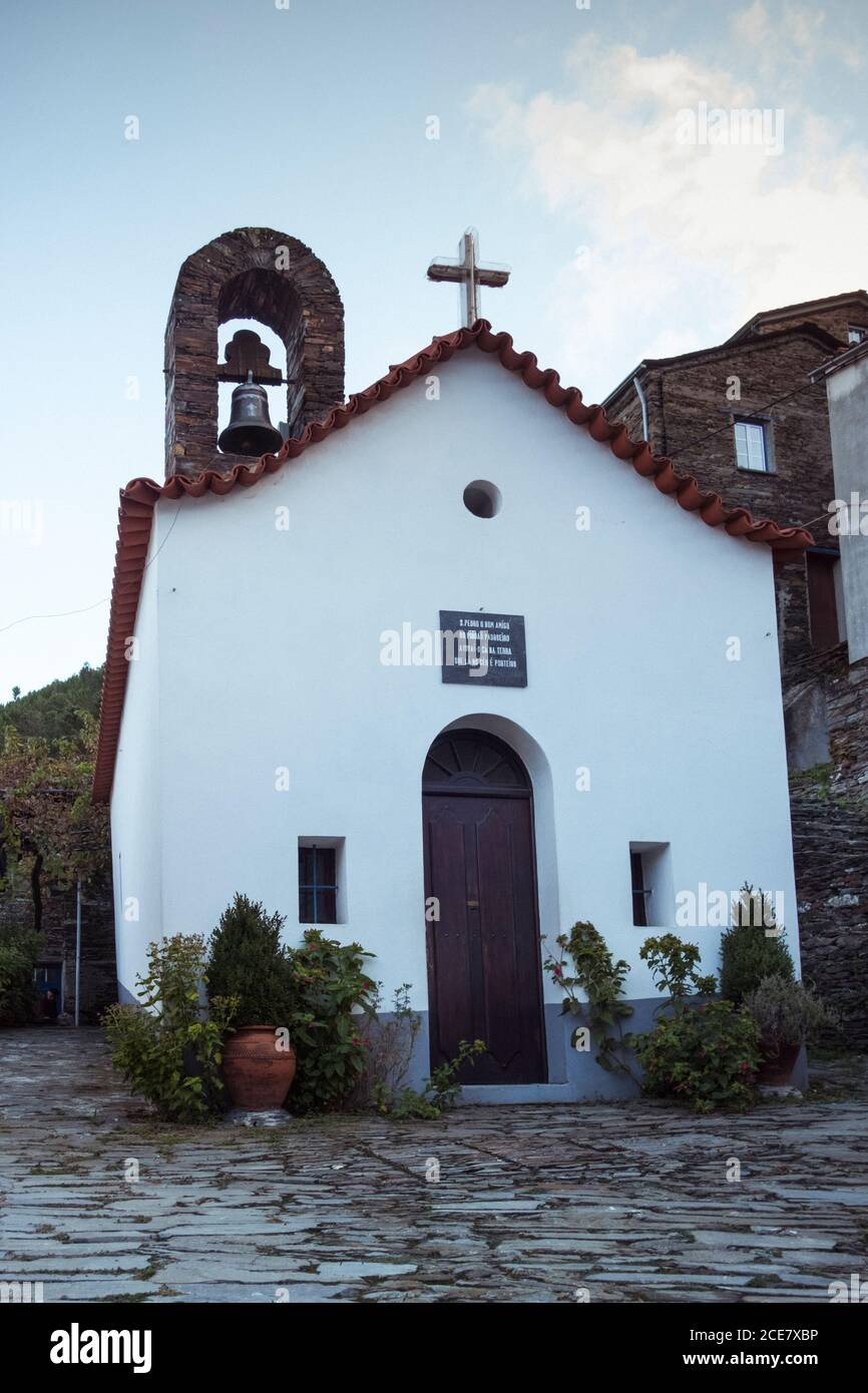 From below of facade of historic temple with pointed columns and cross ...