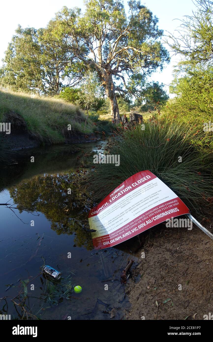 A council closure sign dumped in a river Stock Photo