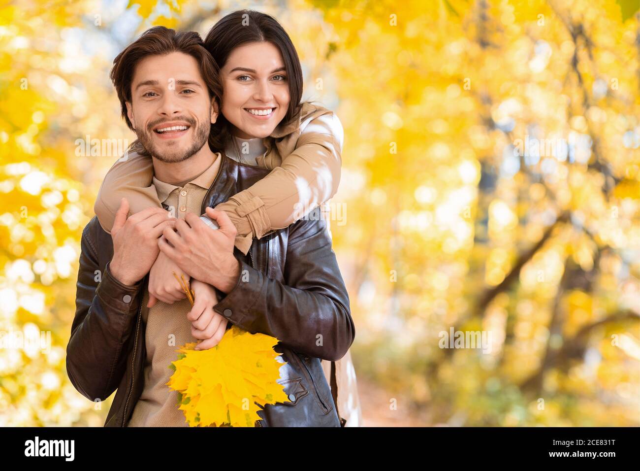 Happy girl in love hugging her man from behind Stock Photo - Alamy