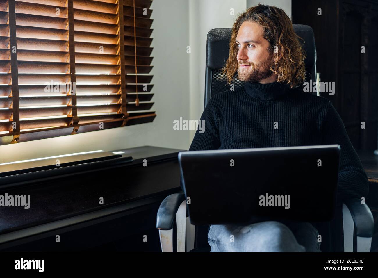 Handsome man working at desktop computer at home Stock Photo