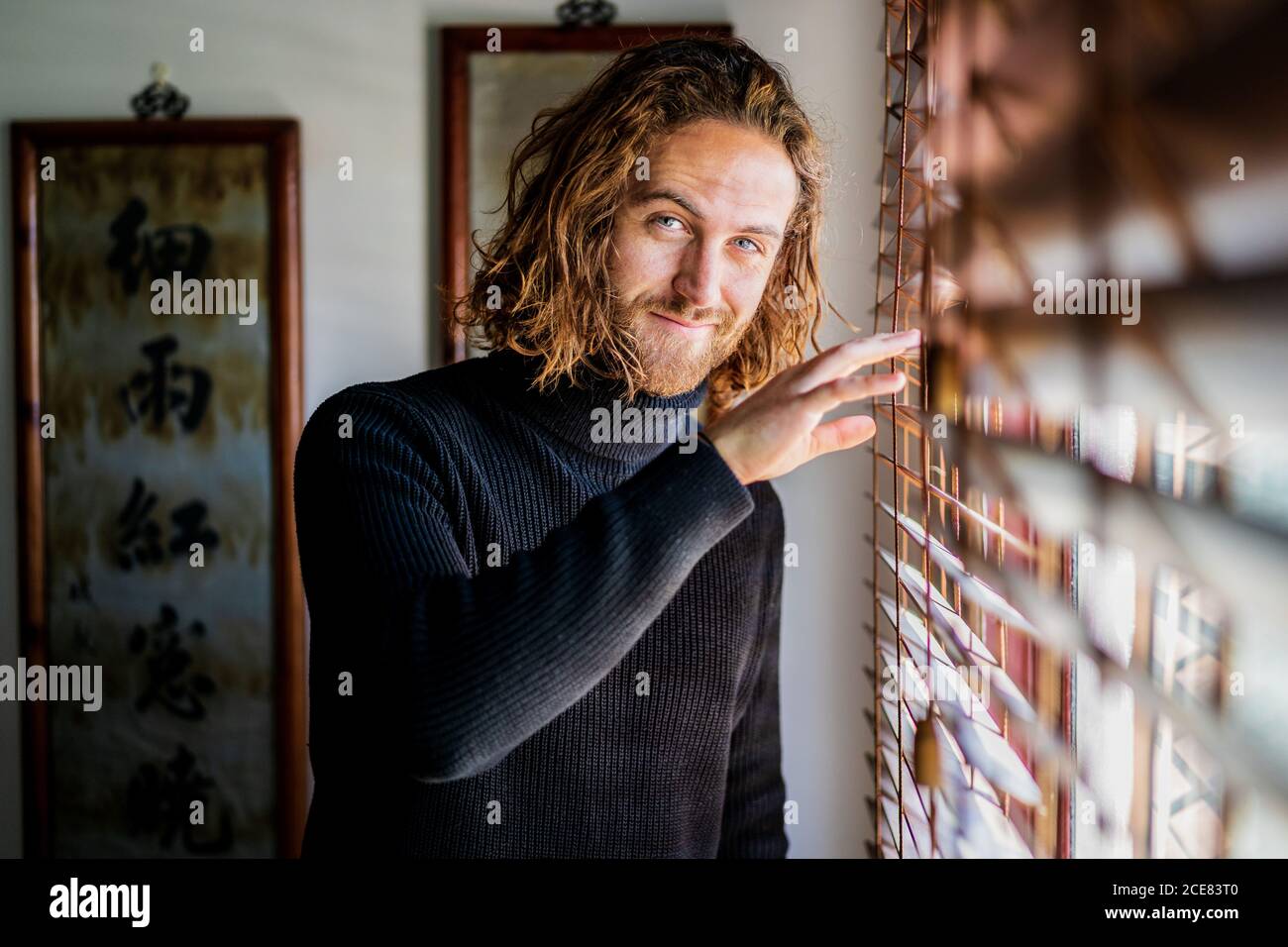 Mature man looking out window Stock Photo
