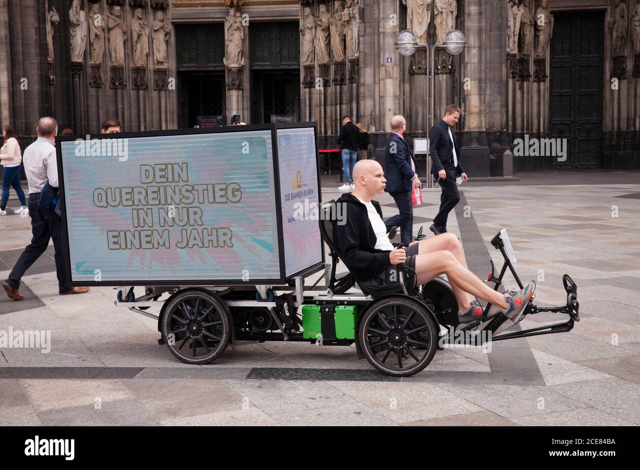 electric bike (trike) with digital 360 degree LED screen for mobile outdoor advertising in front of the cathedral, Cologne, Germany.  elektrisches Bik Stock Photo