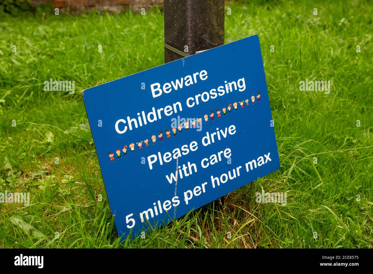 A beware children crossing sign outside a school Stock Photo