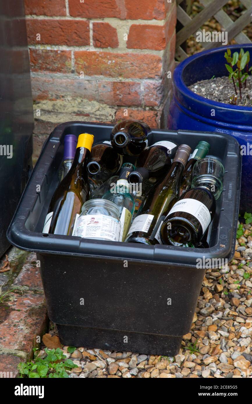 A home bottle bank filled to the top with glass bottles ready to be