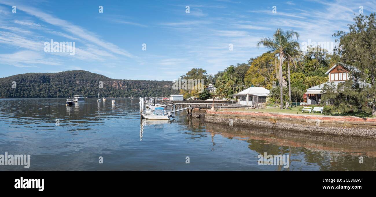 Houses and boats moored along the north east shoreline of Dangar Island  on the Hawkesbury River north of Sydney, Australia Stock Photo