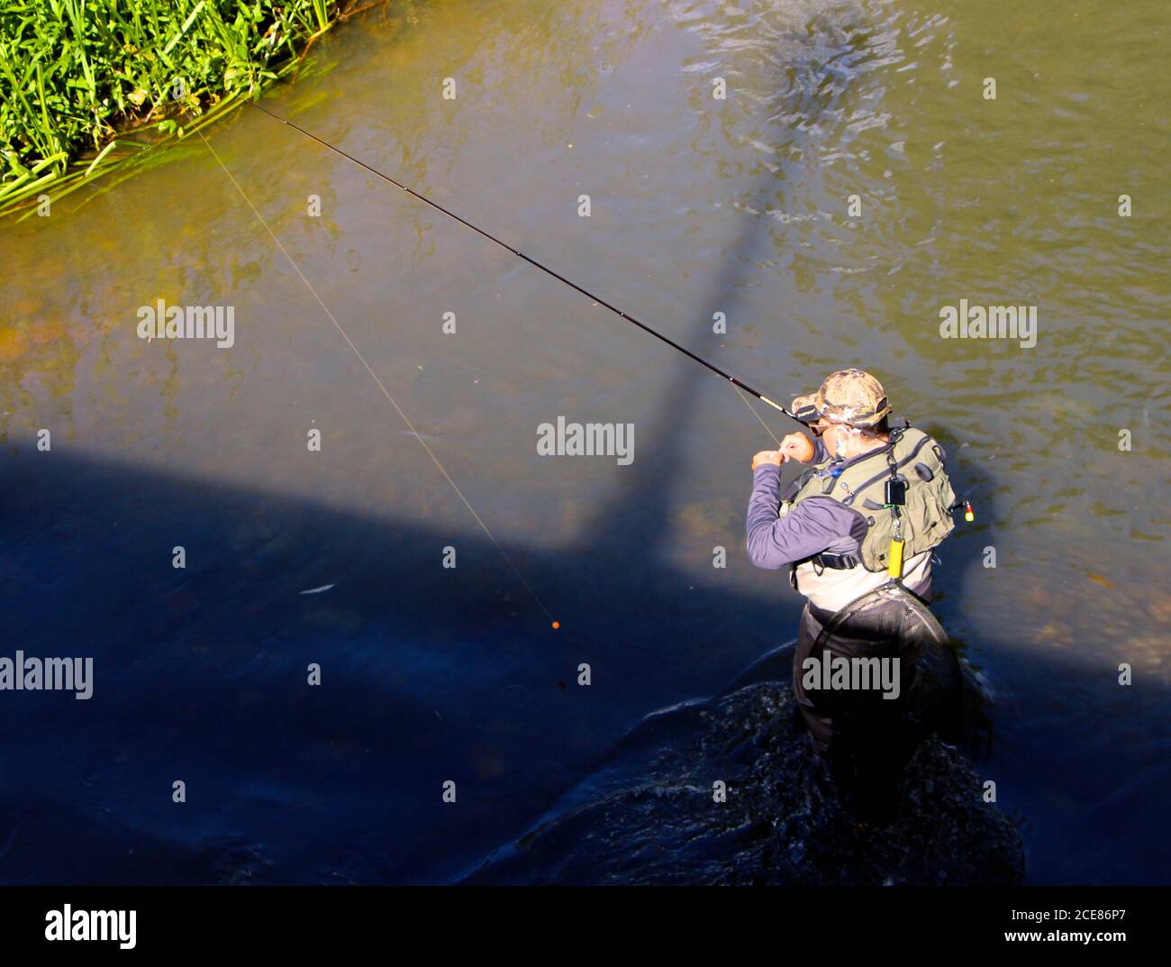 Lone rod and line fisherman in the River Arlanzon Burgos Castile and Leon Spain Stock Photo