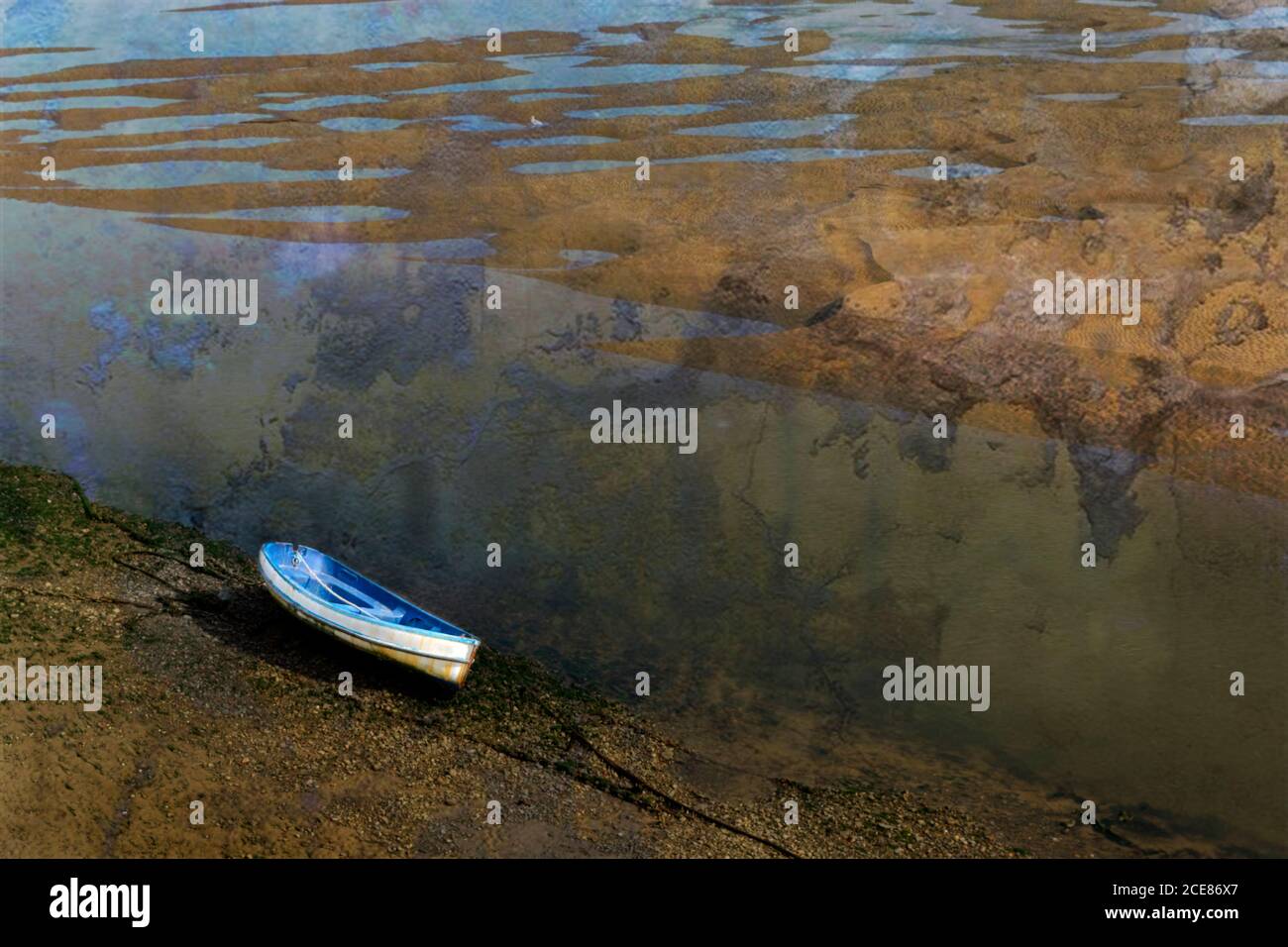 A beached boat anchored while the tide is out Stock Photo