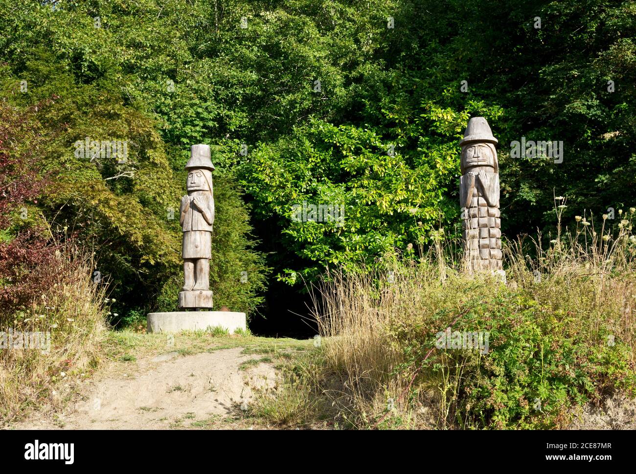 Two Indigenous Welcome Poles face the beach at Burgoyne Bay on Salt Spring Island, British Columbia, Canada Stock Photo