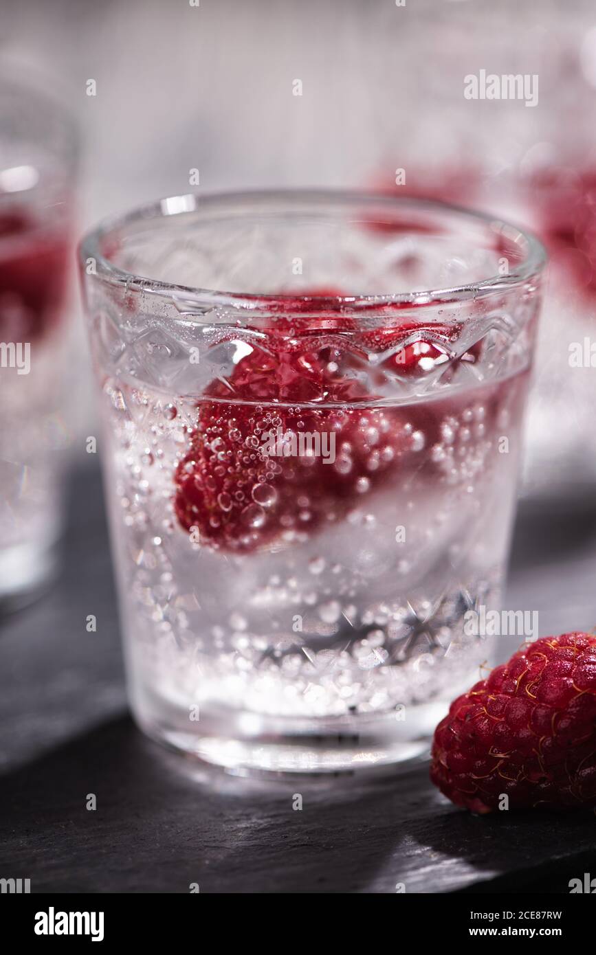 Alcohol shots of berries cocktail with a raspberry Stock Photo Alamy