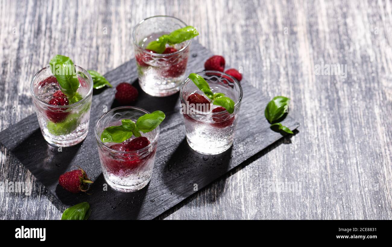 Alcohol shots of berries cocktail with a raspberry Stock Photo
