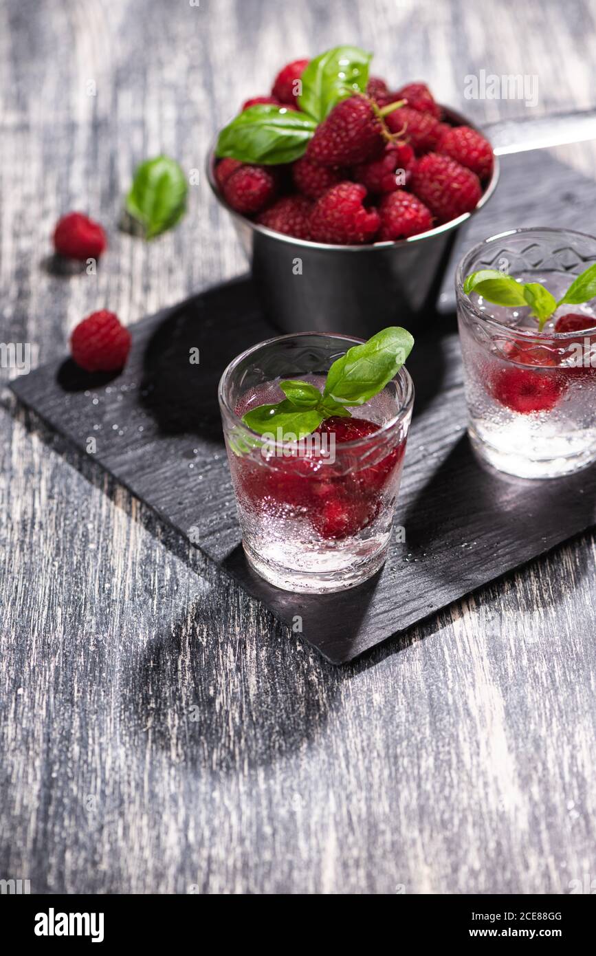 Alcohol shots of berries cocktail with a raspberry Stock Photo