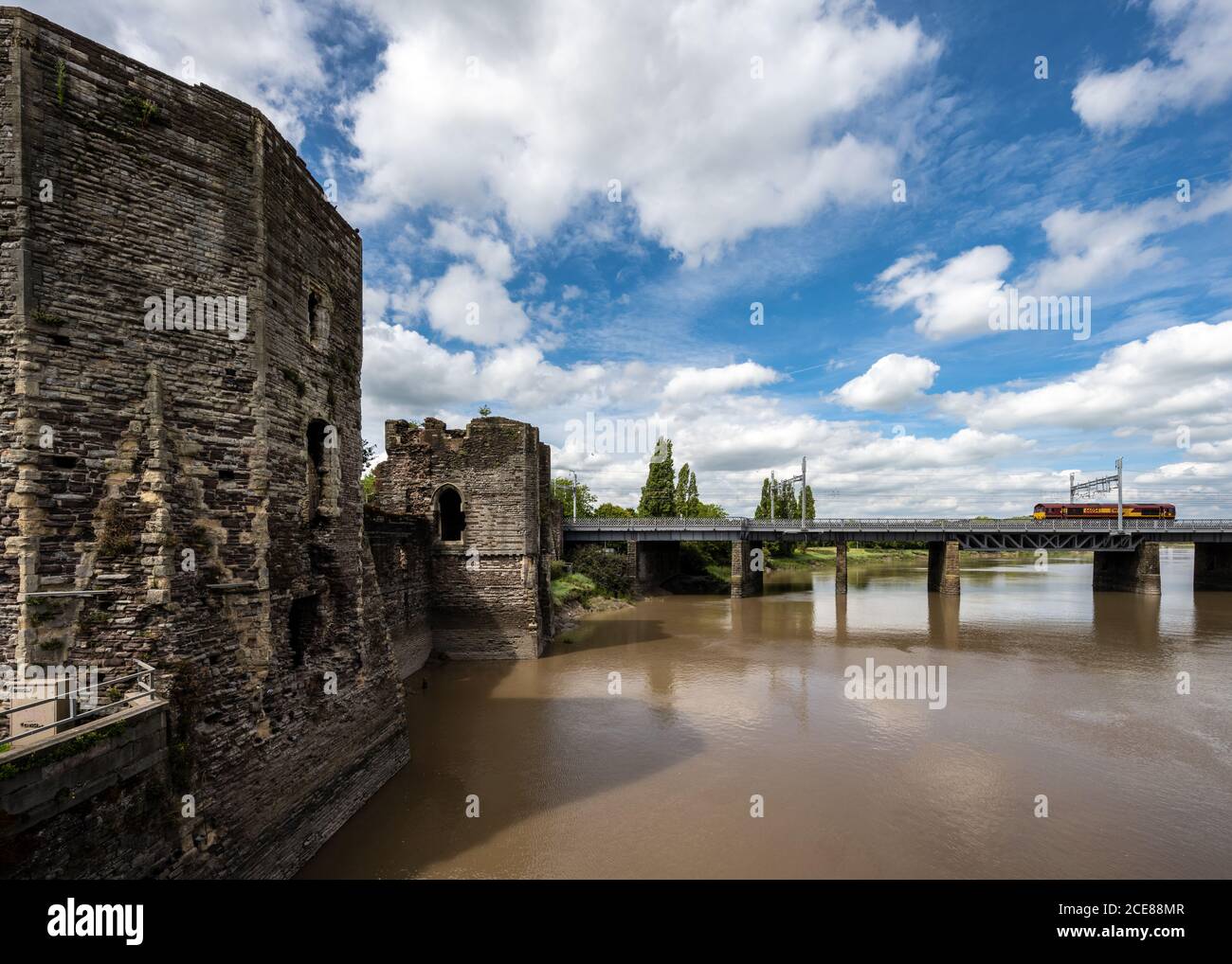 A Class 66 freight locomotive crosses the River Usk outside Newport Castle on the South Wales Main Line railway. Stock Photo