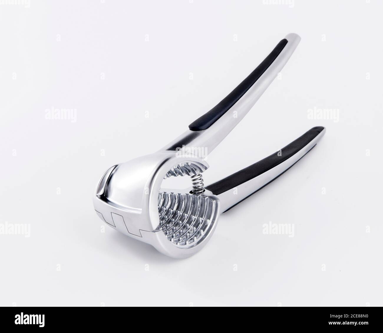 Metal egg slicer with handle placed on white background in studio Stock Photo