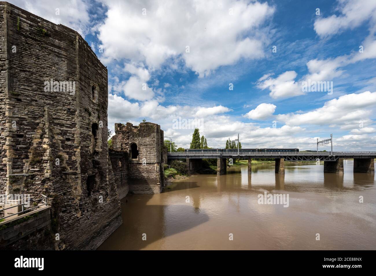 A Great Western Railway Class 158 passenger train crosses the River Usk outside Newport Castle in South Wales. Stock Photo
