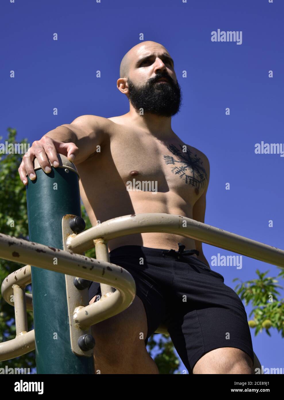 Muscular man stretching arms in hi-res stock photography and images - Alamy