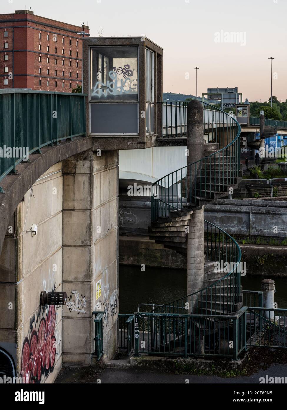 A concrete spiral staircase leads from the quayside of Cumberland Basin to the Pimsoll Bridge flyover on Bristol's Floating Harbour. Stock Photo