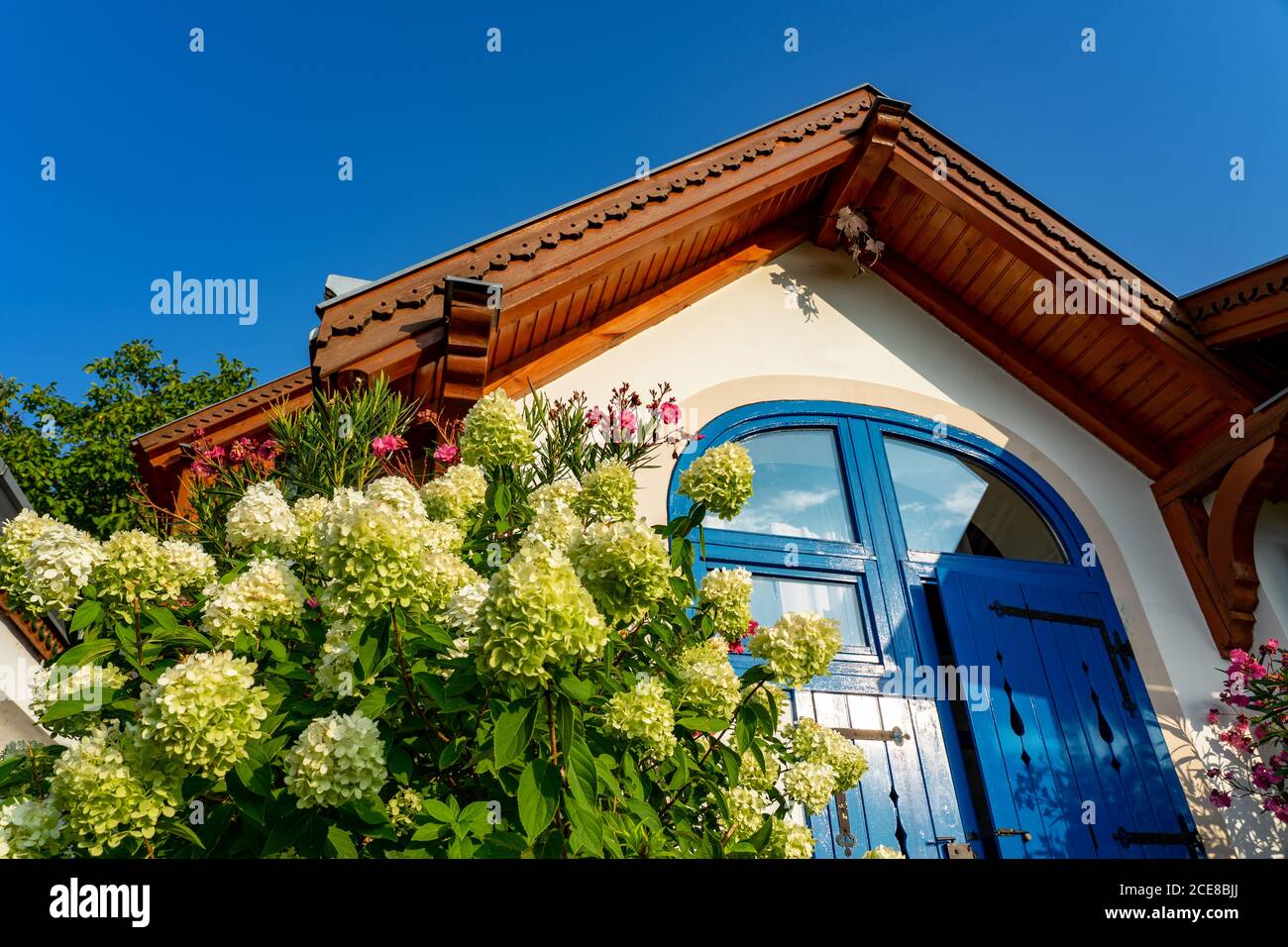 Colorful house entrance in Pecs Hungary with many flowers Stock Photo