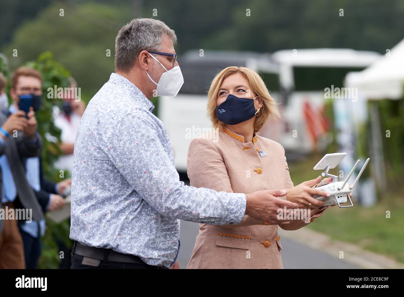 Winningen, Germany. 31st Aug, 2020. Federal Minister of Agriculture Julia  Klöckner (CDU) and drone pilot Freimut Stephan are piloting a pest control  drone in the Moselle vineyards. As part of the German