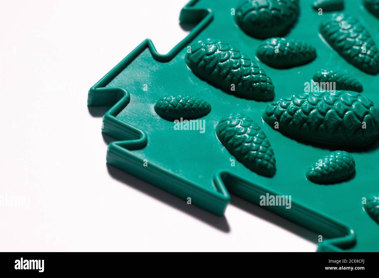 A green orthopedic mat with the design of cones to prevent flat feet. Stock Photo