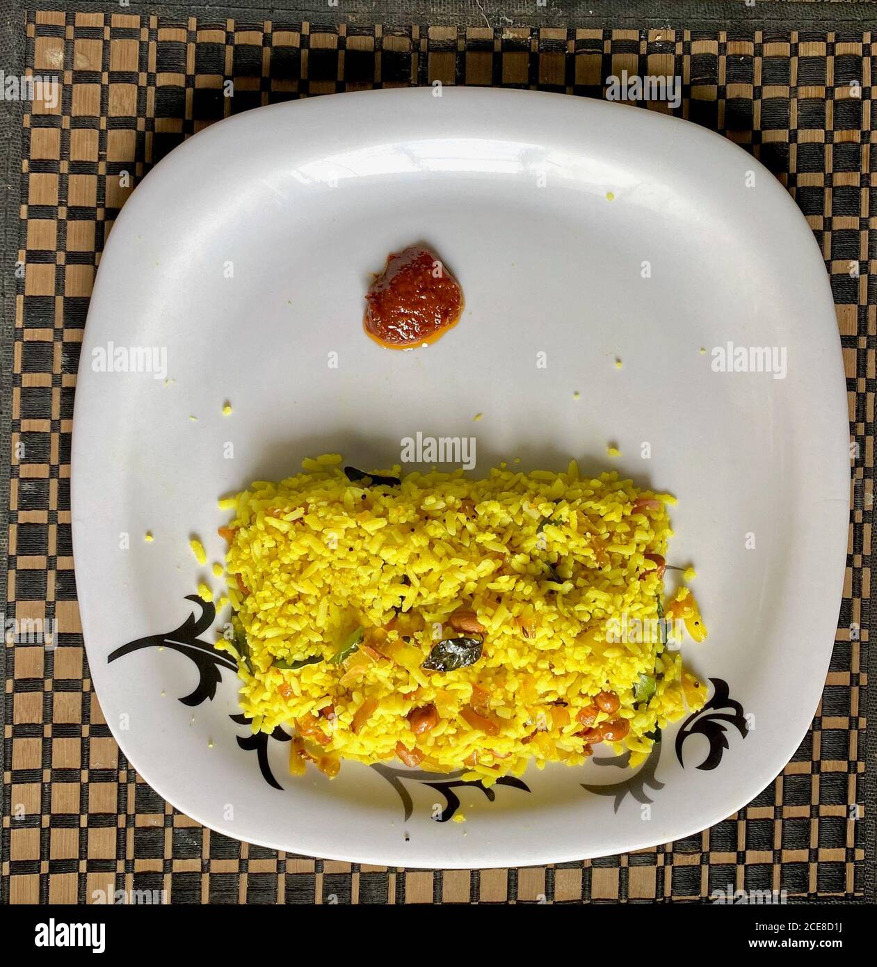 beaten rice or pooha with ginger pickle being served in a plate Stock Photo