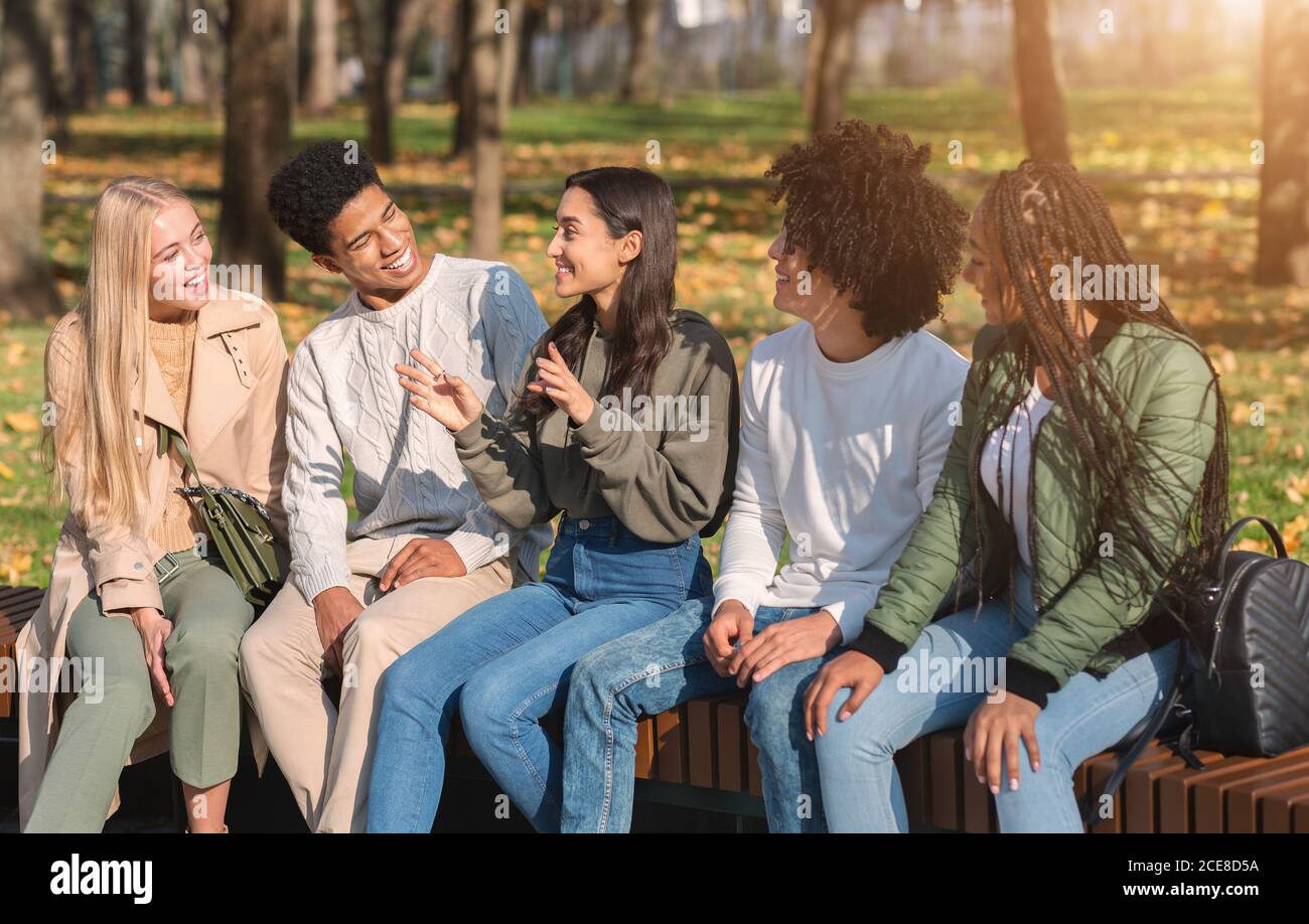 Cheerful international students having break in park Stock Photo