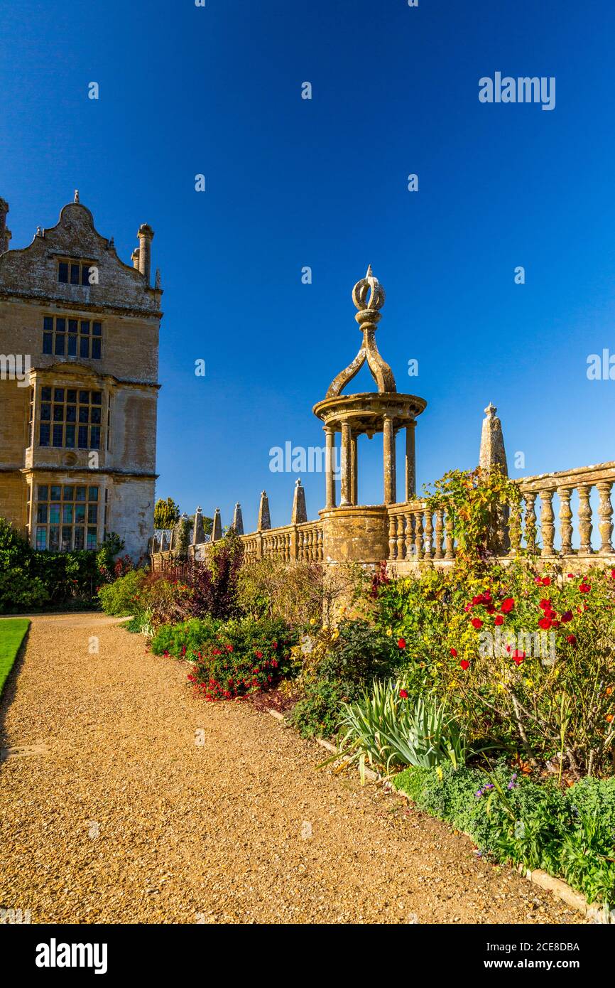 Part of the east front and a colourful herbaceous border at Montacute House, Somerset, England, UK Stock Photo