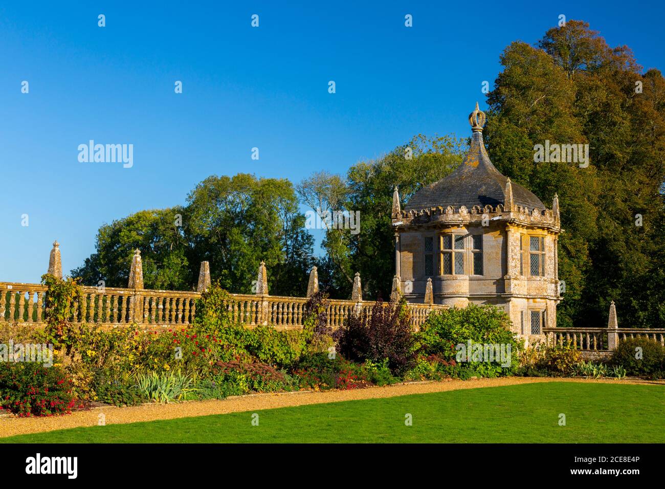 A stone gazebo on th east lawn and the first signs of autumn colour on the trees at Montacute House, Somerset, England, UK Stock Photo