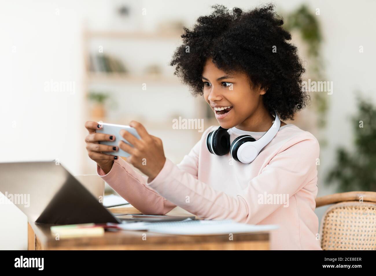 Happy Afro American girlfriend and boyfriend play games on