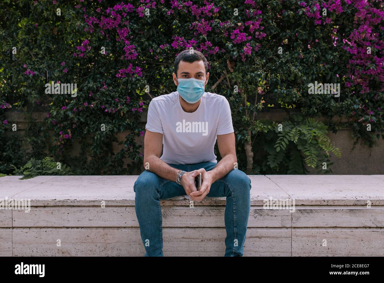 Young man at the park wearing a face mask outdoors during a pandemic ...