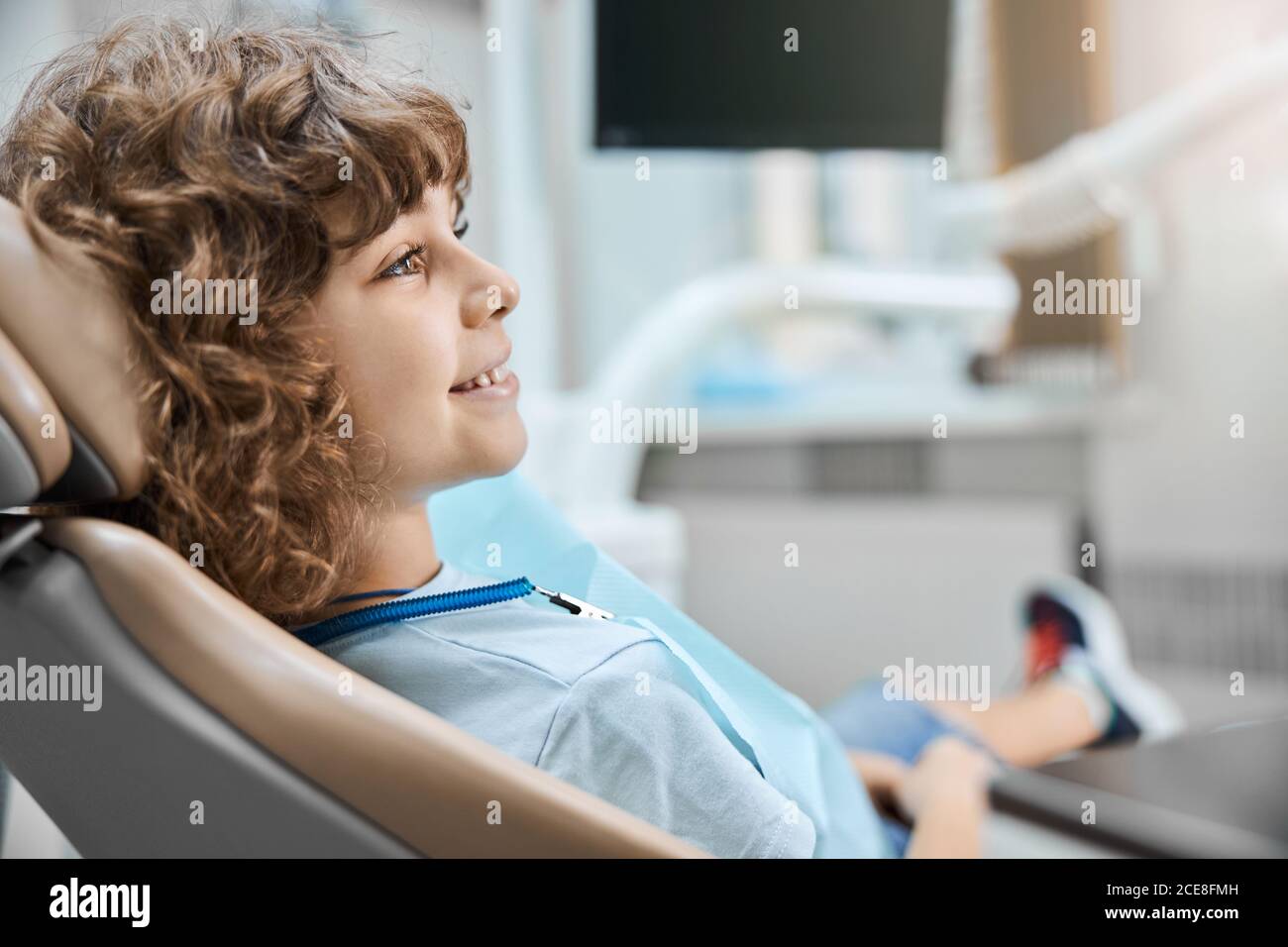 Lovely kid sitting in a dentists office ready for a check-up Stock Photo