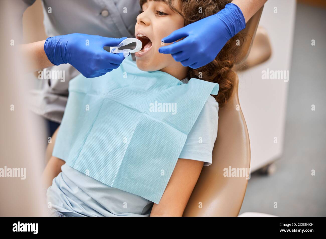 Dentist using a disposable dental rubber dam Stock Photo Alamy