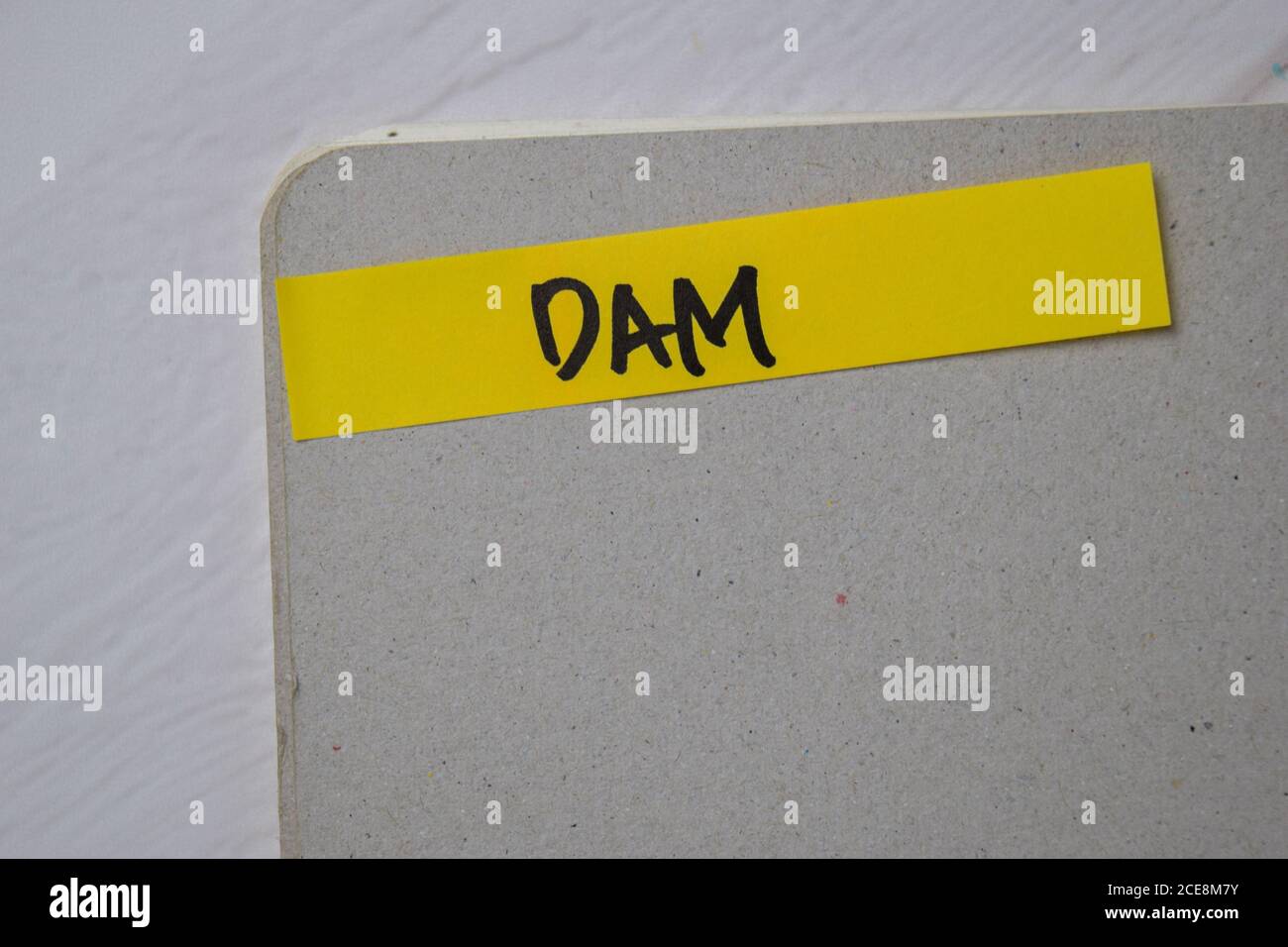 DAM write on sticky notes isolated on office desk Stock Photo - Alamy