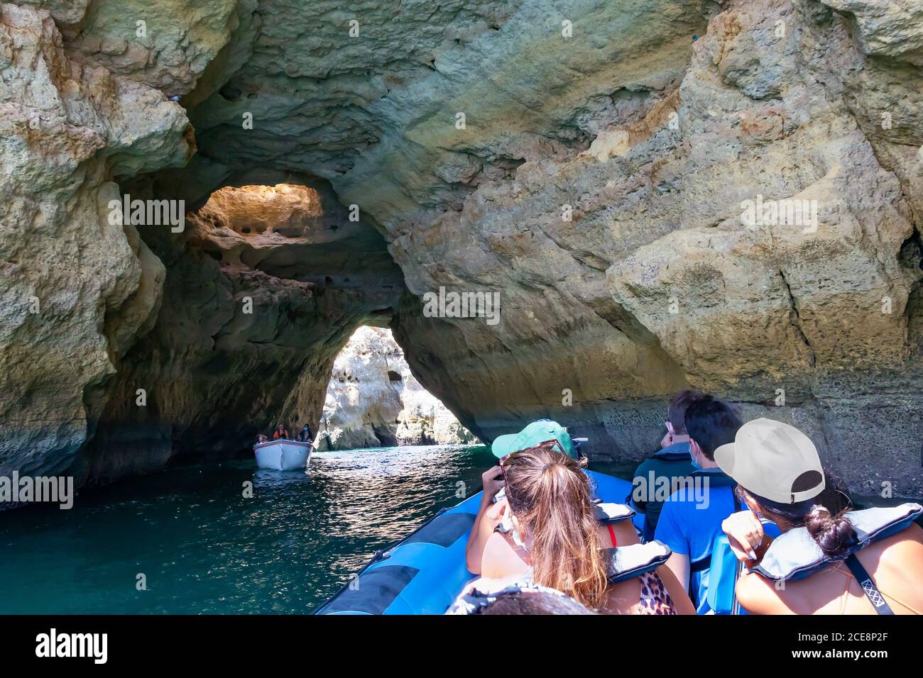 A group of tourist in a boat visiting the caves of Benagil Stock Photo