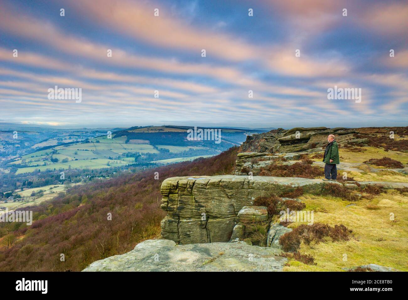 A man admires the view from Curbar Edge. Stock Photo