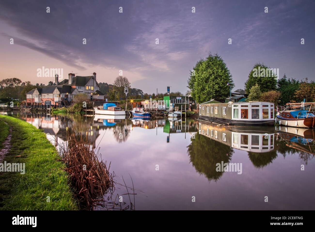 Houseboat on the river Soar with cruisers near The Otter pub and restaurant. Stock Photo