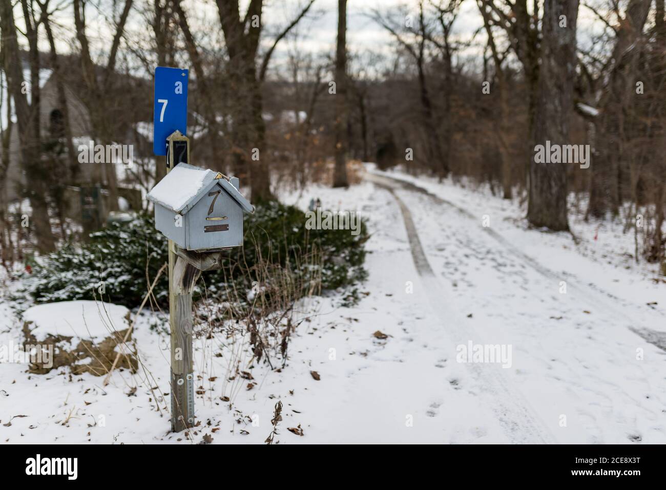 A house shaped wooden mailbox covered with snow, winter scene Stock Photo