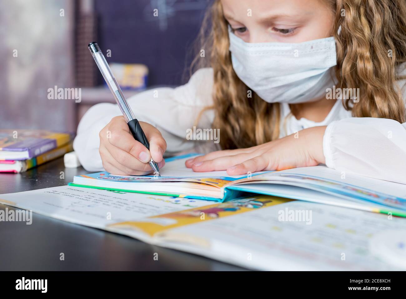 Child with face mask back at school after covid-19 quarantine and ...