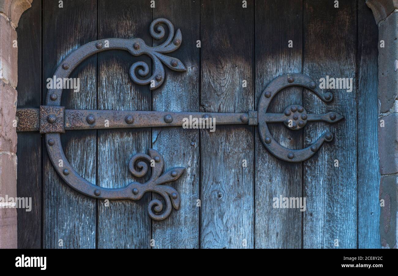 An ornate wrought iron door hinge. Stock Photo