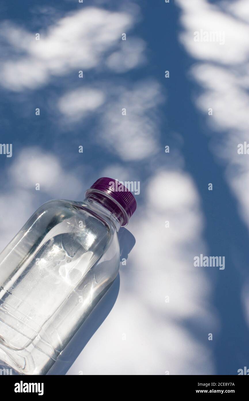Cold Natural Spring Water with drops in small plastic bottles on white  marble table Stock Photo - Alamy