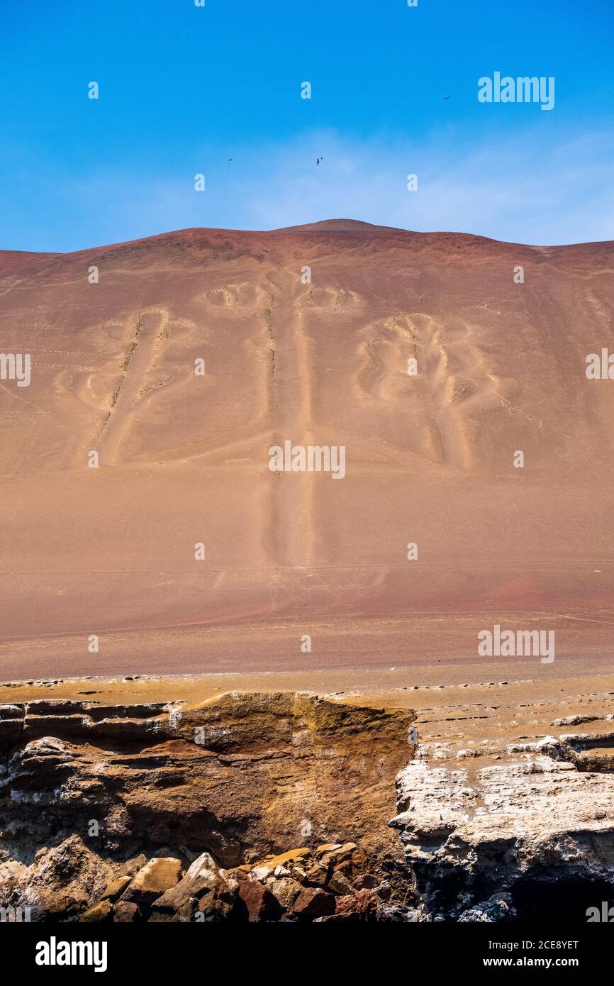 The famous Candelabra lines carved into a hillside facing the sea in Paracas. Stock Photo